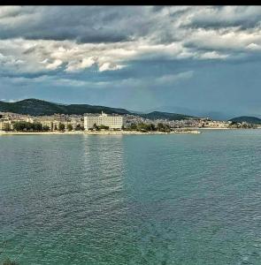 a large body of water with a city in the background at Overwave Apartment in Kavála