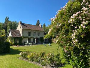 a house with a yard with pink flowers at La Maison d'Aline - Honfleur - Maison d'Hôte De Charme A La Normande in Honfleur +72 photos
