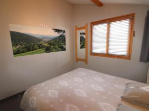 a bedroom with a bed and a window at Gîte Cornimont, 2 pièces, 2 personnes - FR-1-589-41 in Cornimont