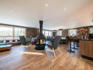 a living room with a fireplace and a dining room at Gîte Ban-sur-Meurthe-Clefcy, 7 pièces, 14 personnes - FR-1-589-366 in Ban-sur-Meurthe-Clefcy