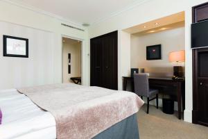 Säng eller sängar i ett rum på Elite Park Avenue Hotel