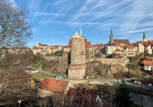 a castle on a hill with a city in the background at East BOX 40A - Ferienhaus in Modern Art in Bautzen