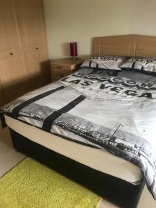 a bedroom with a bed with a blanket on it at Private room Bishop Norton in Market Rasen