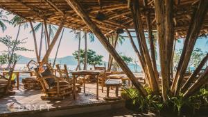 a restaurant on the beach with chairs and tables at Dryft Darocotan Island in El Nido