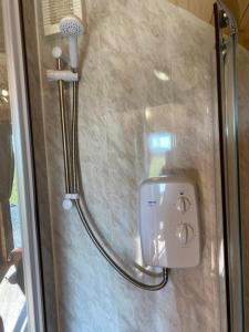 a shower in a bathroom with a shower head at North Point Pods NC500 in Thurso +84 photos
