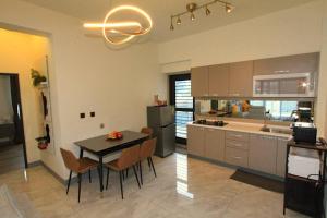 a kitchen with a table and chairs in a kitchen at Modern Chic in Hengchun South Gate
