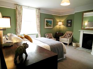 a bedroom with a dog standing in front of a bed at Upper Buckton B&B in Leintwardine