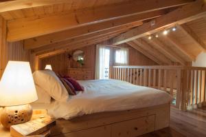 a bedroom with a bed in a room with wooden ceilings at Chalet Lisa Ski-in, ski-out Well equipped in Nendaz