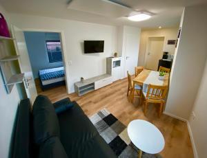 a living room with a couch and a table at Ihre Vorteilswelt in Gielow