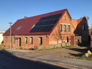 a brick house with solar panels on the roof at Ihre Vorteilswelt in Gielow