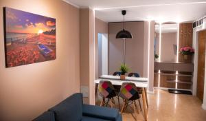 a living room with a table and chairs in a room at Anastasia SeaSide in Mangalia