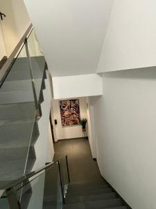 a hallway with stairs and a painting on the wall at Royal Flats in Las Palmas de Gran Canaria