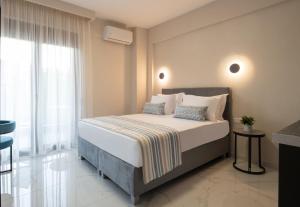 a bedroom with a bed and a large window at VagAthan - Lux Holidays in Afitos