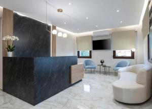 a lobby with a waiting room with a table and chairs at VagAthan - Lux Holidays in Afitos
