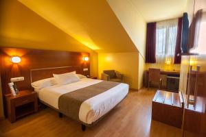 a hotel room with a bed and a desk at Hotel Andia in Orcoyen