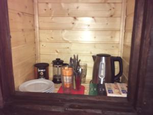 a shelf with a coffee maker and other items on it at O Fogar do Monte in Sober