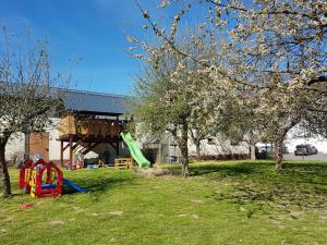 a park with a playground with a slide and trees at Ferienwohnung/Monteurzimmer auf dem Bauernhof in Mörlenbach
