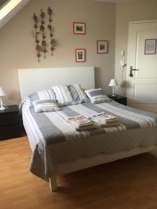 a bedroom with a bed with two pillows on it at Chambres d'Hôtes Coteaux Sud in Jurançon