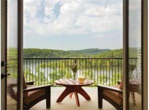 a balcony with a table and benches and a view at Hilton Grand Vacations Club Long Creek Ridgedale in Ridgedale +2 photos