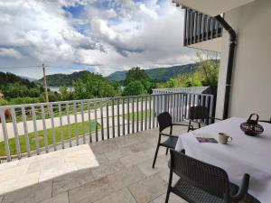 a patio with a table and chairs on a balcony at Villa Recica North in Bled +39 photos