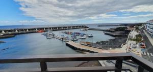 a group of boats docked in a river with a bridge at LA MARINA III ÁTICO B in La Restinga +1 photo