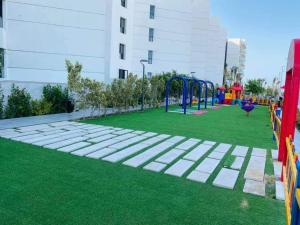 een speeltuin in een gebouw met groen gras bij شاليه للايجار بورتو سعيد in Port Said