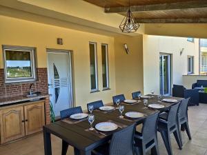 a dining room with a long table and chairs at Refúgio da Ria in Vagos