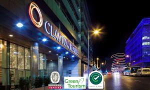 a building with a sign on the side of a street at Clayton Hotel Cardiff Lane in Dublin