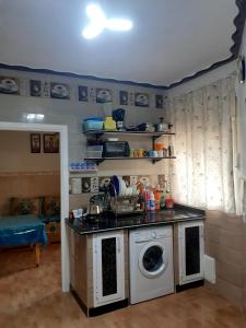a kitchen with a washing machine in a room at Apartamento con wifi in Nador