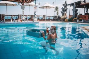 a girl in a swimming pool with a mask on her face at Ashyana Candidasa Beach Resort in Candidasa