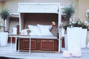 a canopy bed with pillows on a patio at Gut Weissenhof in Radstadt +33 photos