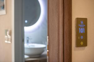 a close up of a bathroom door with a sink at VagAthan - Lux Holidays in Afitos