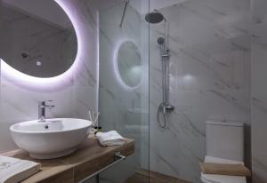 a bathroom with a sink and a glass shower at VagAthan - Lux Holidays in Afitos