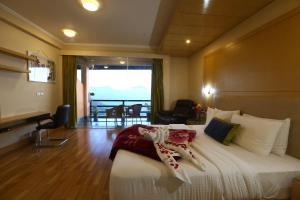 a hotel room with a bed and a balcony at The Byke Nature Vilas Pure Veg in Shimla