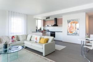 a living room with a white couch and a glass table at Kurviertel Wohnung IV in Überlingen