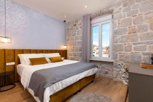 Posteľ alebo postele v izbe v ubytovaní Luxury rooms Spalatum