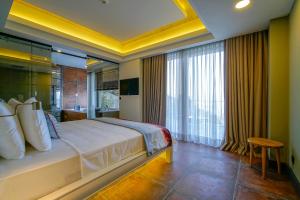 a bedroom with a large bed and a large window at Cape Krio Boutique Hotel & SPA - Over 12 years old Adult Only in Datca