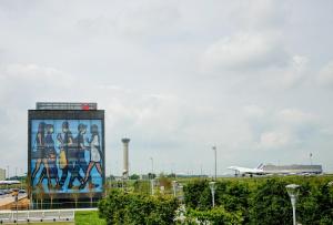 a mural on the side of a building at an airport at citizenM Paris Charles de Gaulle Airport in Roissy-en-France