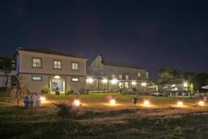 a house with lights in the yard at night at Casa das Jardas in Idanha-a-Nova