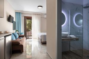 a bathroom with a couch and a sink in a room at VagAthan - Lux Holidays in Afitos
