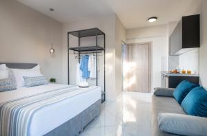 a bedroom with a large bed and a couch at VagAthan - Lux Holidays in Afitos