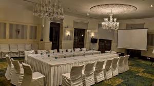 a conference room with a long table and chairs at Royal Orchid Brindavan Garden Mysore in Belagula