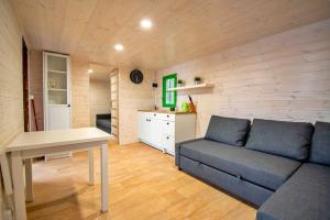 a living room with a couch and a table at Sielanka Mazury in Szczytno