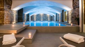 a swimming pool in a building with a ceiling at Boscolo Lyon Hotel & Spa in Lyon