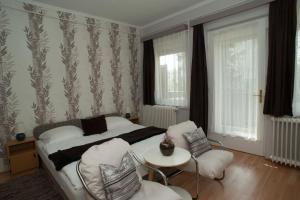 Posteľ alebo postele v izbe v ubytovaní Oleander Apartman