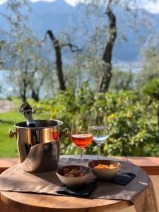 a table with a drink and a bowl of food and a wine glass at B&B Casa Benamati by Kelly in Malcesine