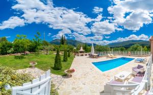 a villa with a swimming pool and mountains at Country Style Villa Christina in Pouláta