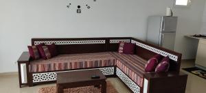 a couch with pillows on it in a living room at Dar Lebharr Kélibia in Kelibia