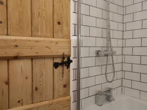 a bathroom with a wooden door and a shower at Mount Pleasant Cottage in Grange Over Sands +15 photos