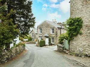 an old stone house on a street at Mount Pleasant Cottage in Grange Over Sands